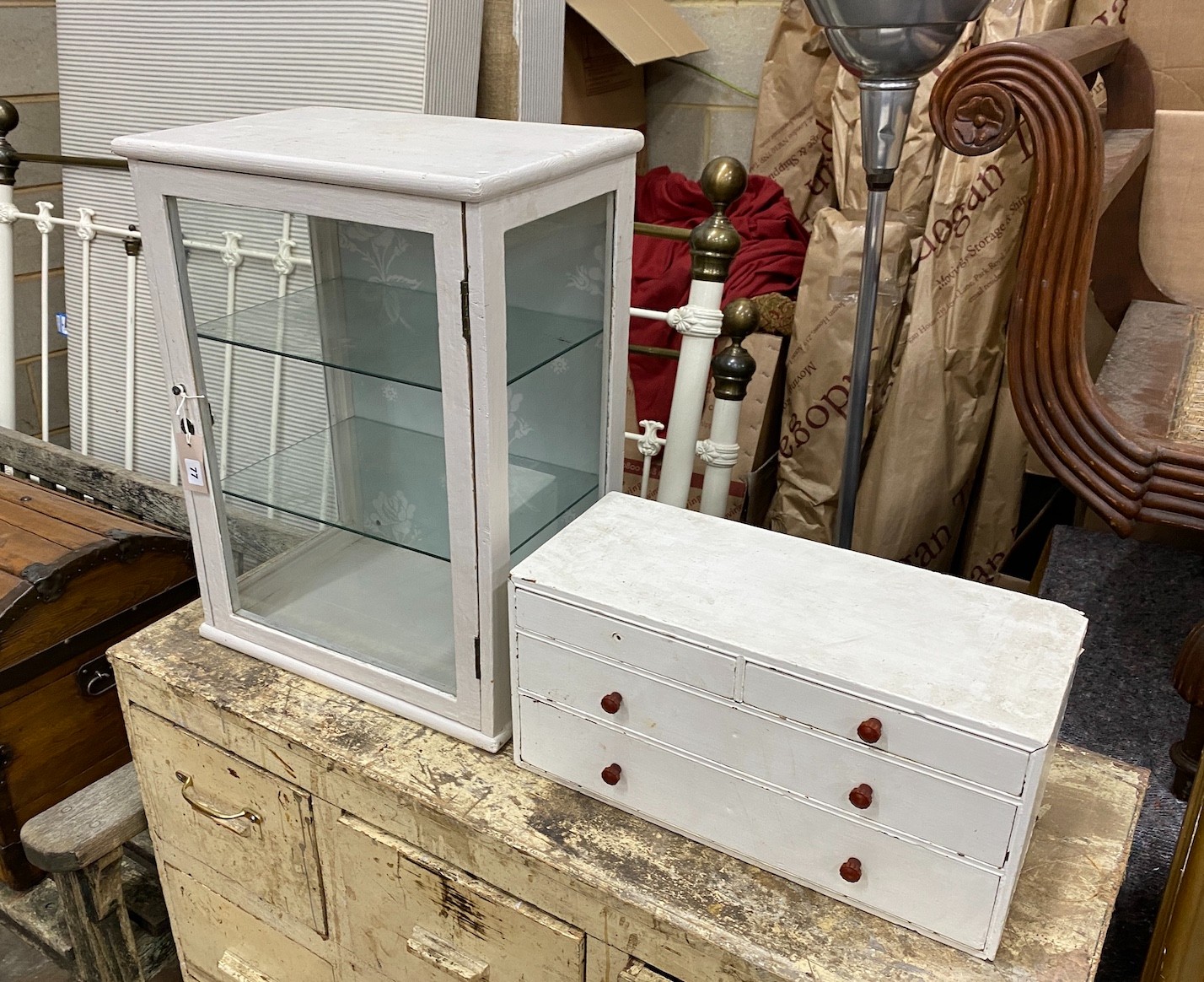 An early 20th century counter top display cabinet, later painted, width 46cm, depth 30cm, height 60cm together with a small pine nest of drawers